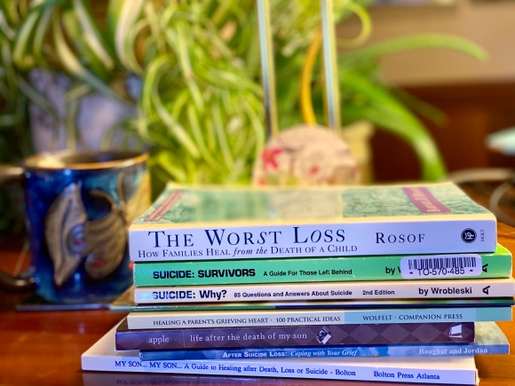 Photo of a stack of books about suicide loss