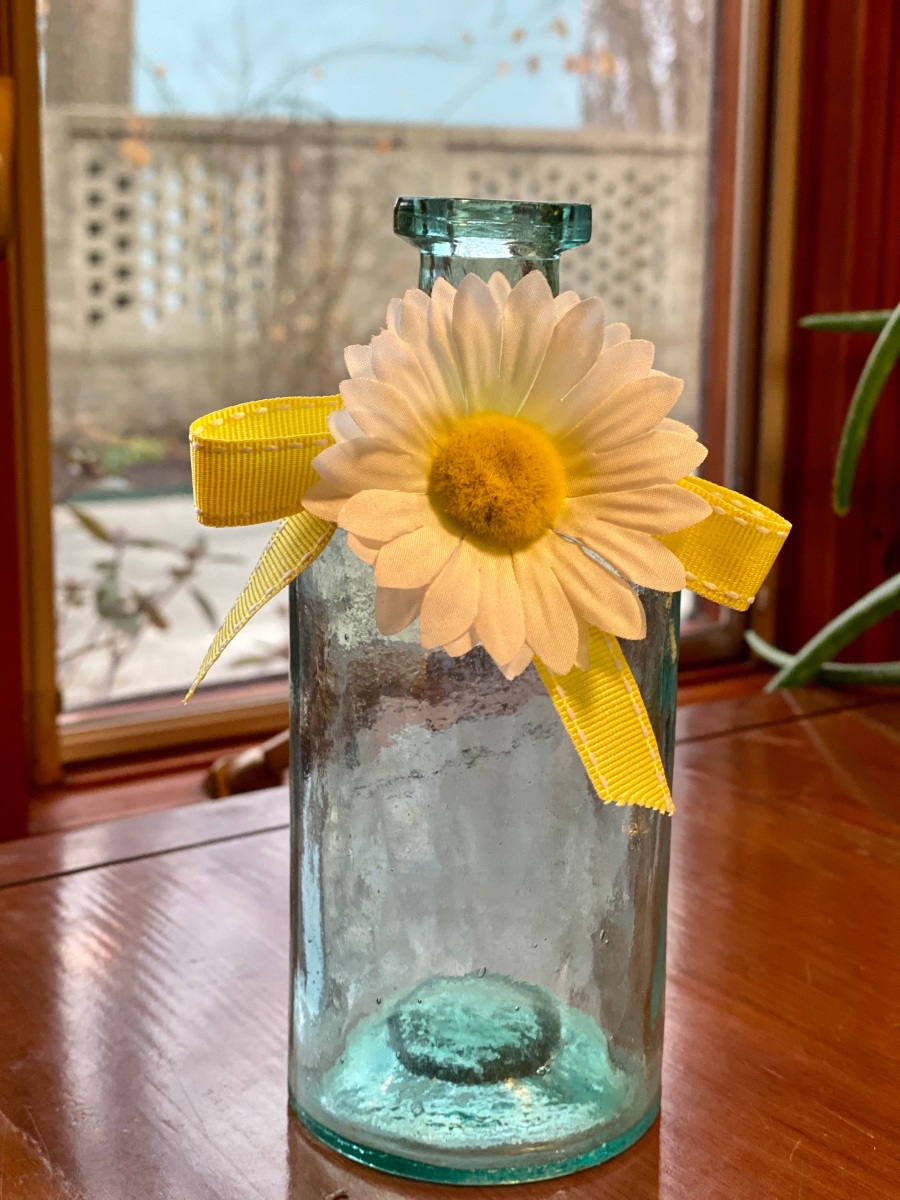 Yellow and White Fabric Flower and green glass vase bottle